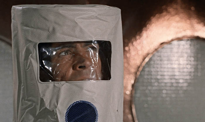 James Bond (Sean Connery) dons a radioactive suit disguise in Dr. No (1962)