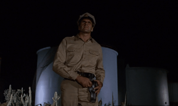 James Bond (Sean Connery) kicks the head of a goon at the beginning of Goldfinger (1964)